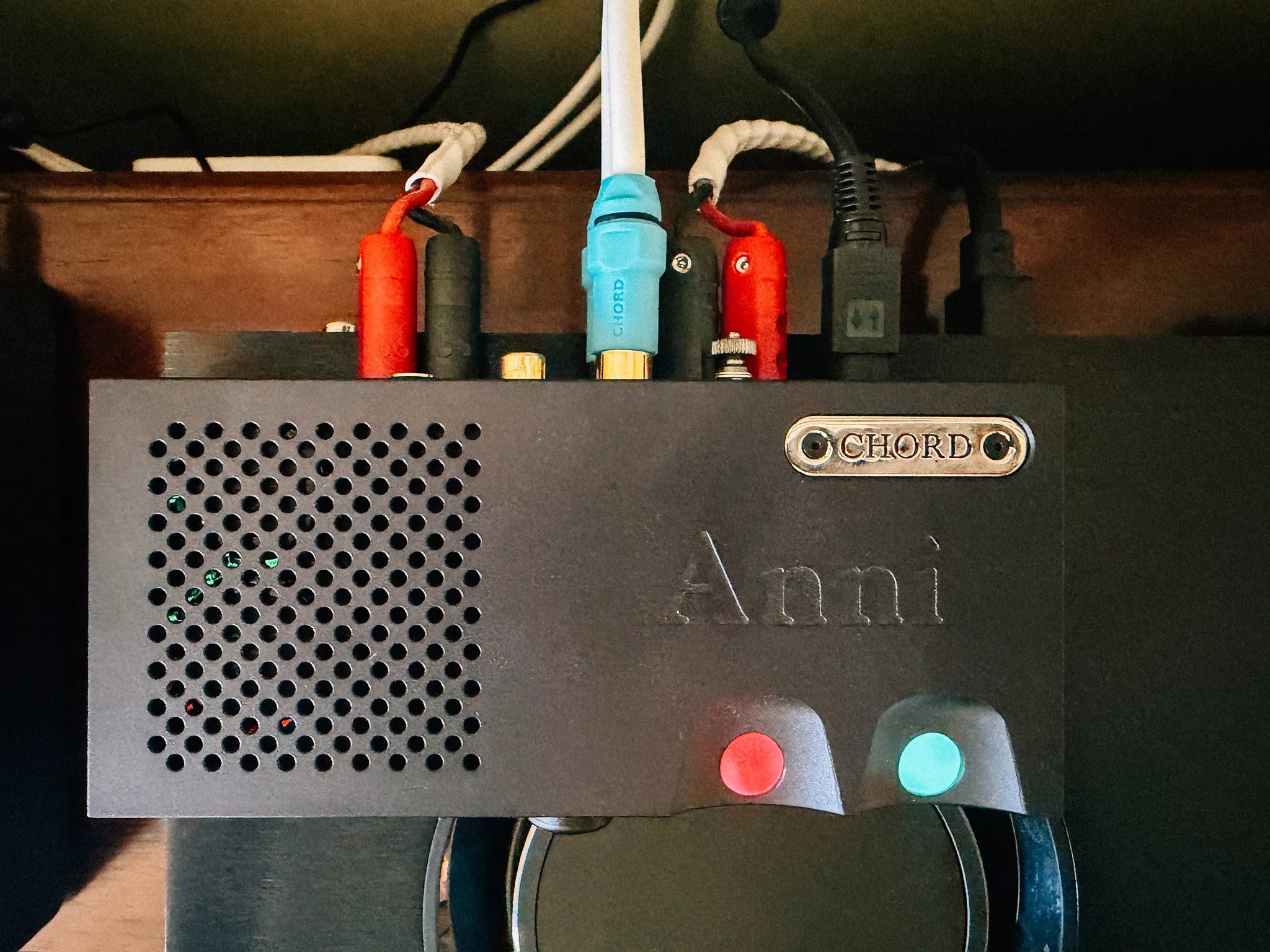 Top down view of the Chord Anni showing its engraved name, the Chord badge, and the gain orb lit red for high gain next to the cyan power orb
