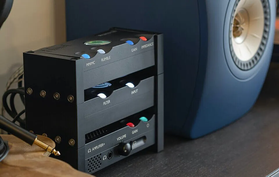 Chord's own press image for the Qutest range: the Huei phono stage, Qutest DAC and Anni amplifier stacked beside a blue KEF LS50 Meta